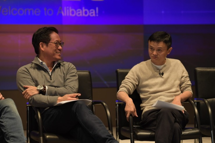 Brian Wong and Jack Ma sit together on a stage.