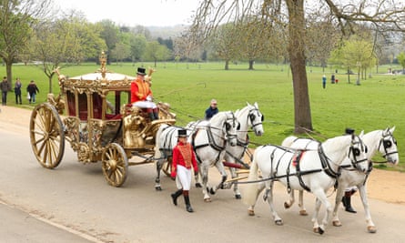 Four white horses pull a replica of King Charles’s coronation carriage through Dulwich Park