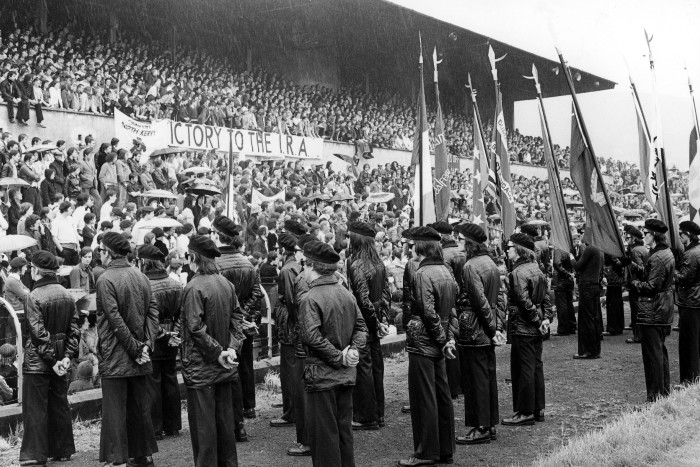 Volunteer members of the Irish Republican Army form a Guard of Honour at the Sinn Féin rally held at Casement Park in 1979