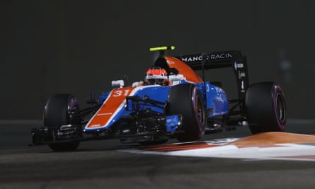 A red, white and blue Formula One car at speed, bouncing over the curb at a corner