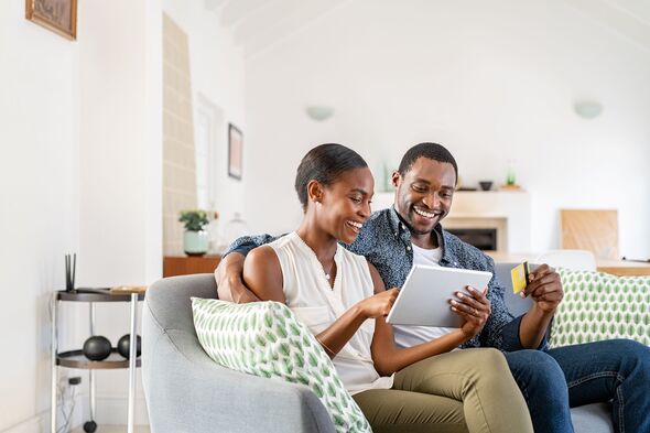 Couple smiling while online banking