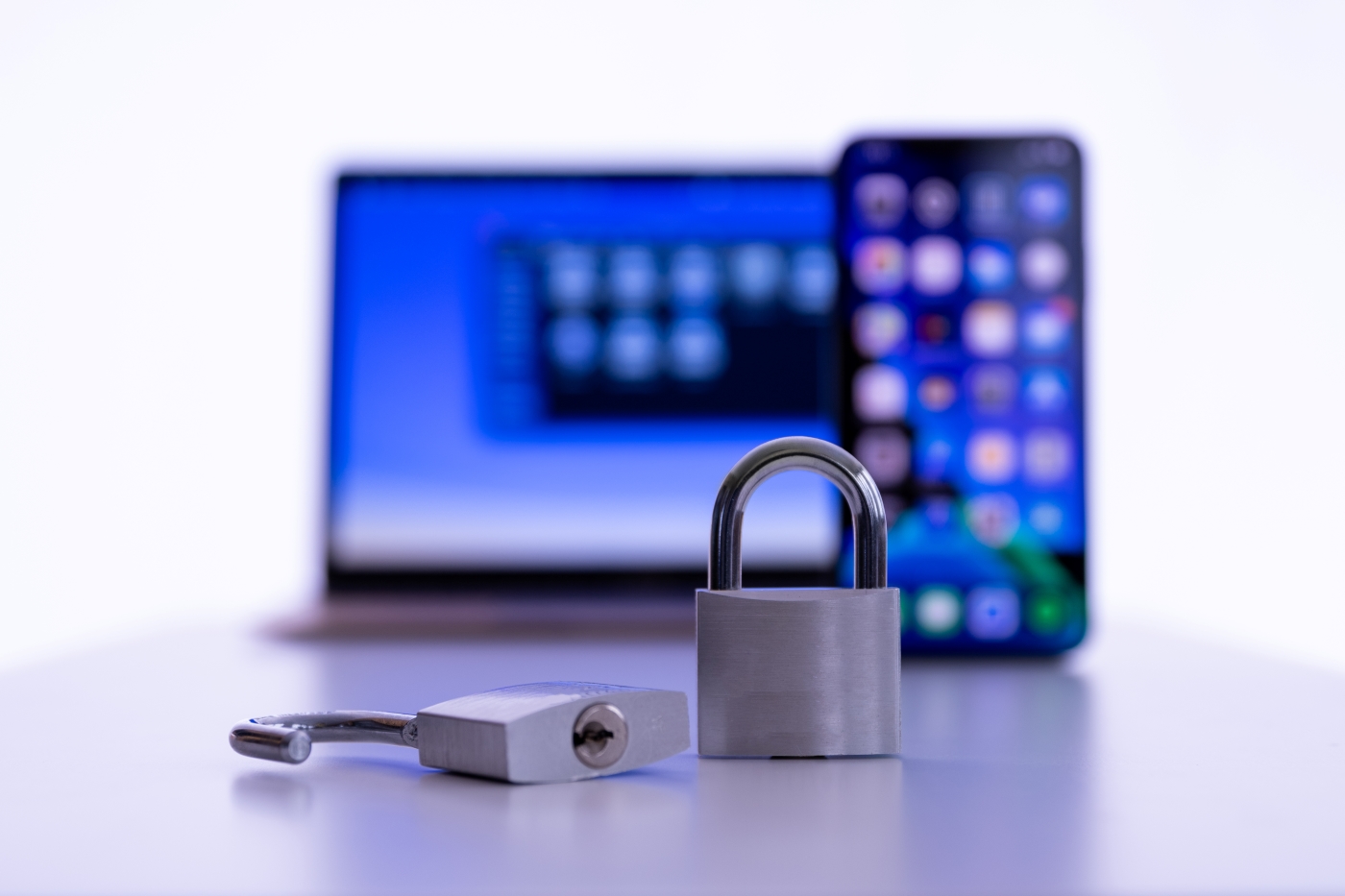 Laptop and smartphone with locked and unlocked padlock