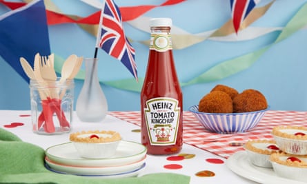 A bottle of limited edition Heinz ‘Kingchup’ on a table with flags and English treats