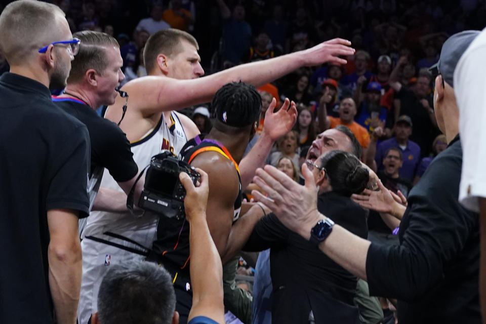 Nikola Jokic mixed it up in the stands on Sunday. (AP Photo/Matt York)