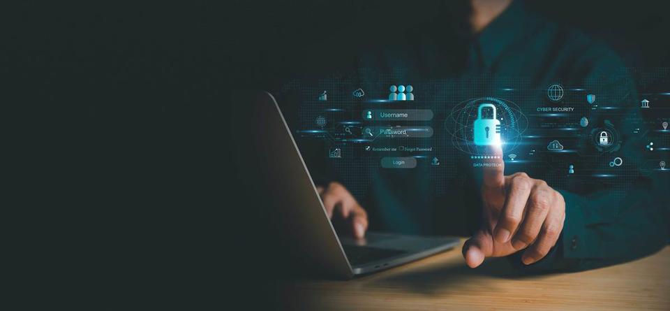 A person sitting with a laptop reaches out to touch a padlock icon floating in the air with other cybersecurity symbols.