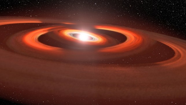 EMBARGOED TO 1500 THURSDAY MAY 4 Undated artist concept image issued by Nasa of concentric gas and dust disks around the star TW Hydrae. Astronomers believe they have found evidence of two planets under construction in a distant young star around 200 light years away from Earth. Scientists have spotted two shadows in a disk of gas and dust surrounding TW Hydrae, thought to be cast by two smaller disks nestled inside the star system. Issue date: Thursday May 4, 2023. PA Photo. See PA story SCIENCE Hydrae. Photo credit should read: John Debes/AURA/STScI/ESA/Nasa/PA Wire NOTE TO EDITORS: This handout photo may only be used in for editorial reporting purposes for the contemporaneous illustration of events, things or the people in the image or facts mentioned in the caption. Reuse of the picture may require further permission from the copyright holder.