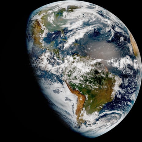 A satellite image shows wildfire plumes over North America.