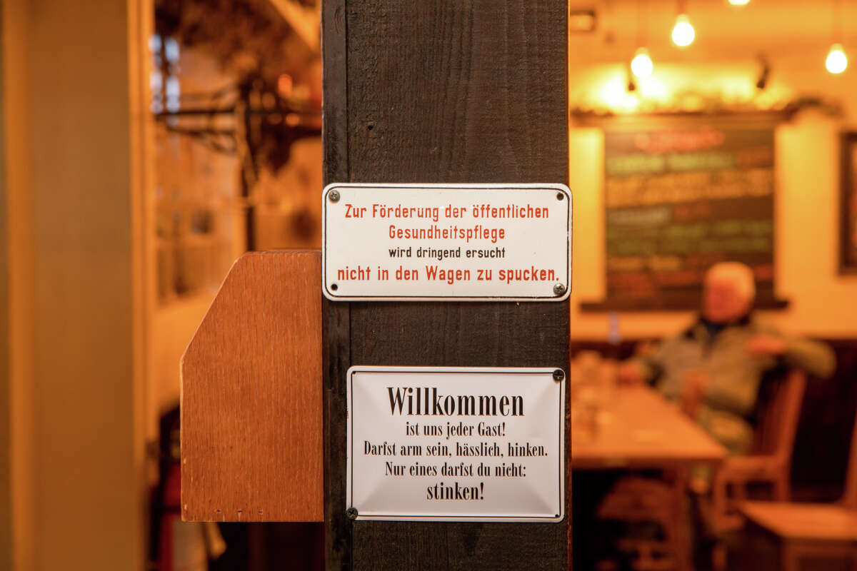 A sign in German hangs in the beer hall at Gourmet Haus Staudt in Redwood City, Calif., on Jan. 14, 2022.