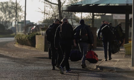 offshore workers walking with duffle bags