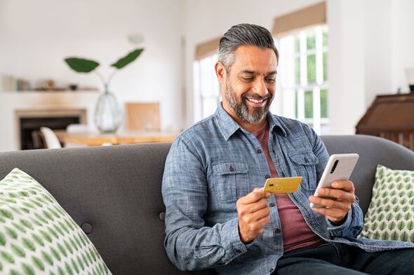 Man smiling while online banking