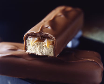 Two stacked milk chocolate bars with caramel and nougat filling