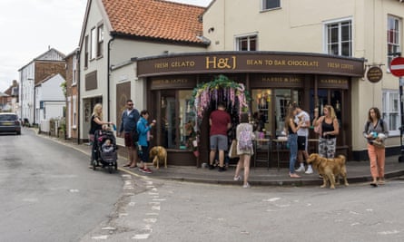 Customers stand outside the Southwold branch of Harris and James