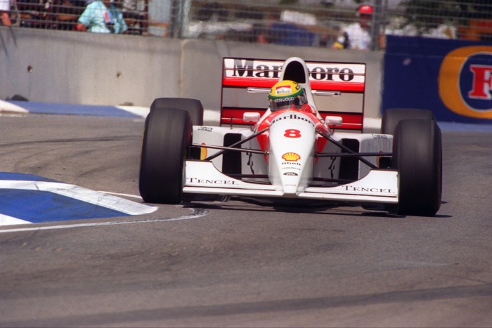 A racing car driver takes a corner in a McLaren car