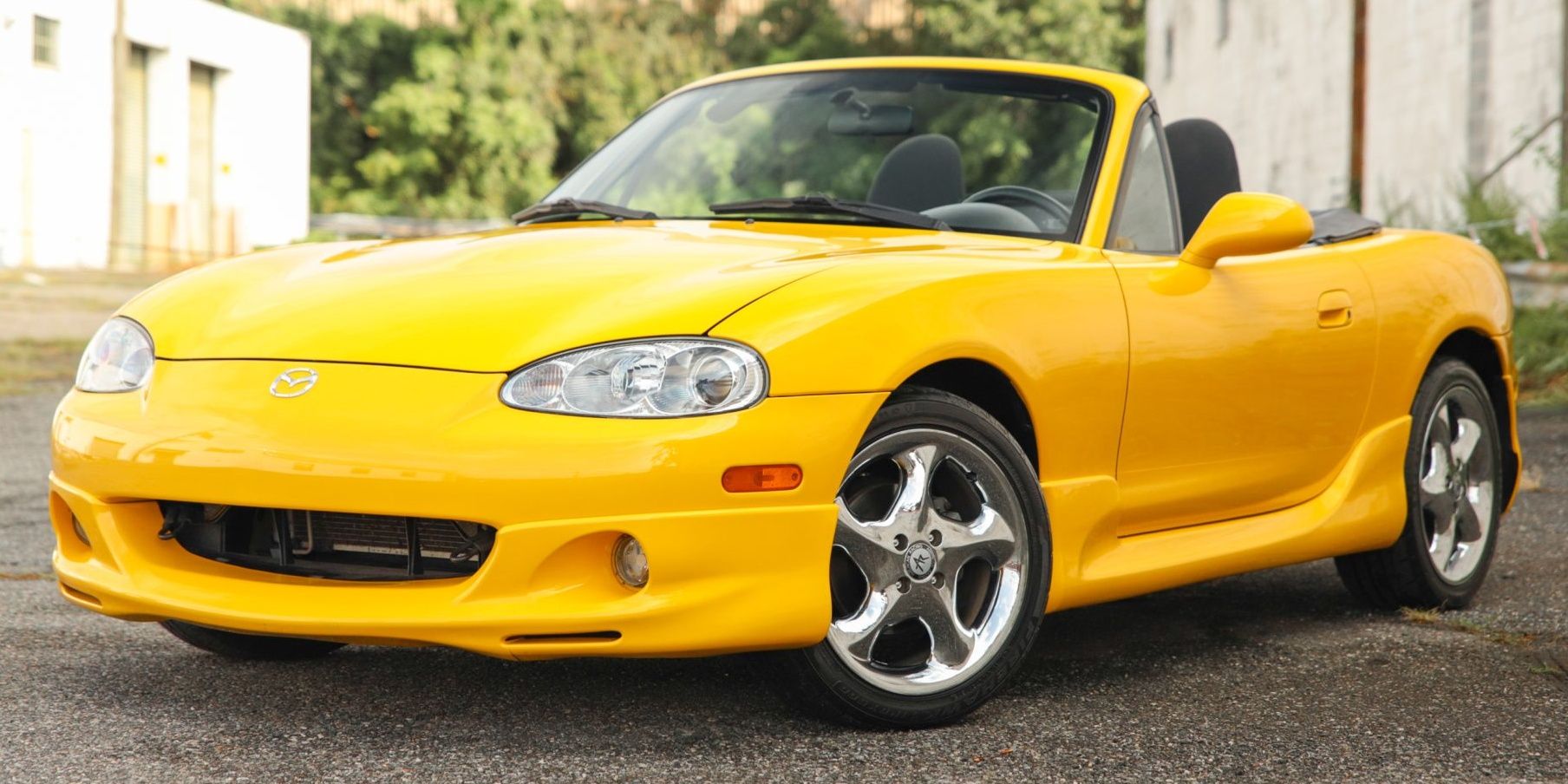 Mazda Miata NB yellow sports car parked