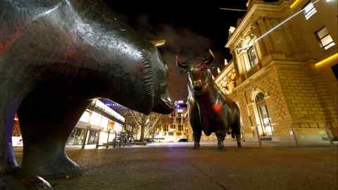 Bull and bear symbols for successful and bad trading in front of the German stock exchange in Frankfurt, Germany