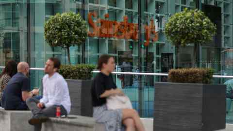 People relax on benches outside Sainsbury’s London HQ