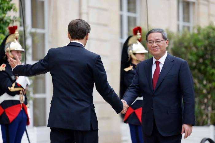 French President Emmanuel Macron, left, greets Li Qiang at the Elysee Palace on the sidelines of the New Global Financial Pact Summit in Paris