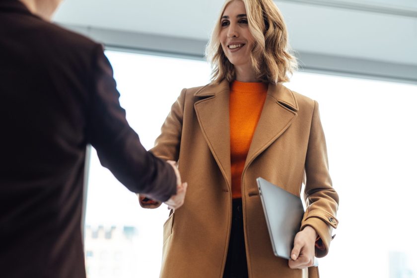 Business women shaking investors hand