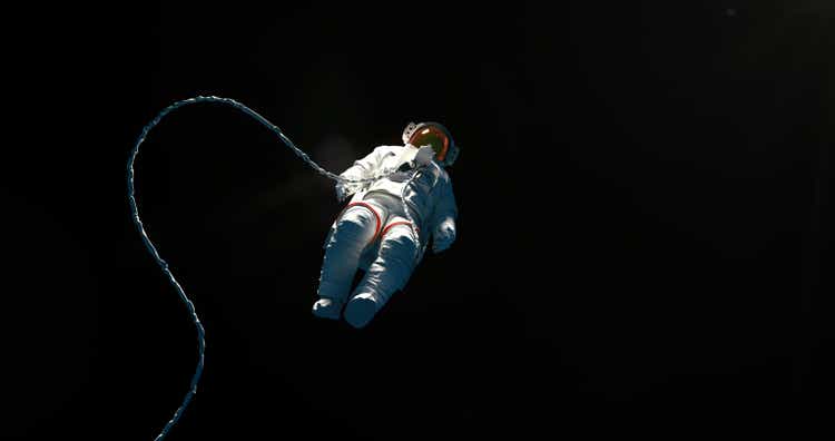 Hovering spaceman on a black background with a copy space for a astroscience topics and designs