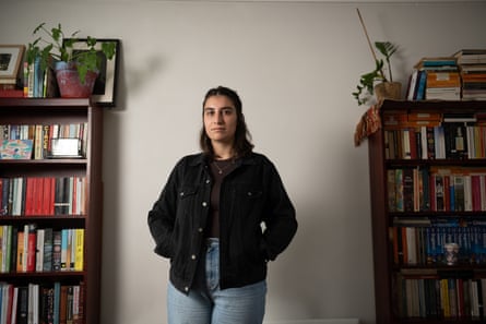 Seymour standing in front of two bookshelves