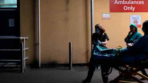 Nurses wheel a patient into the hospital