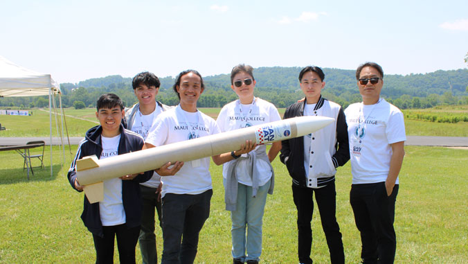 people standing and holding rocket 