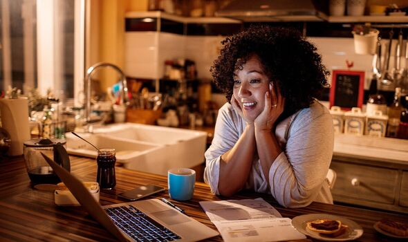 Woman smiling at laptop