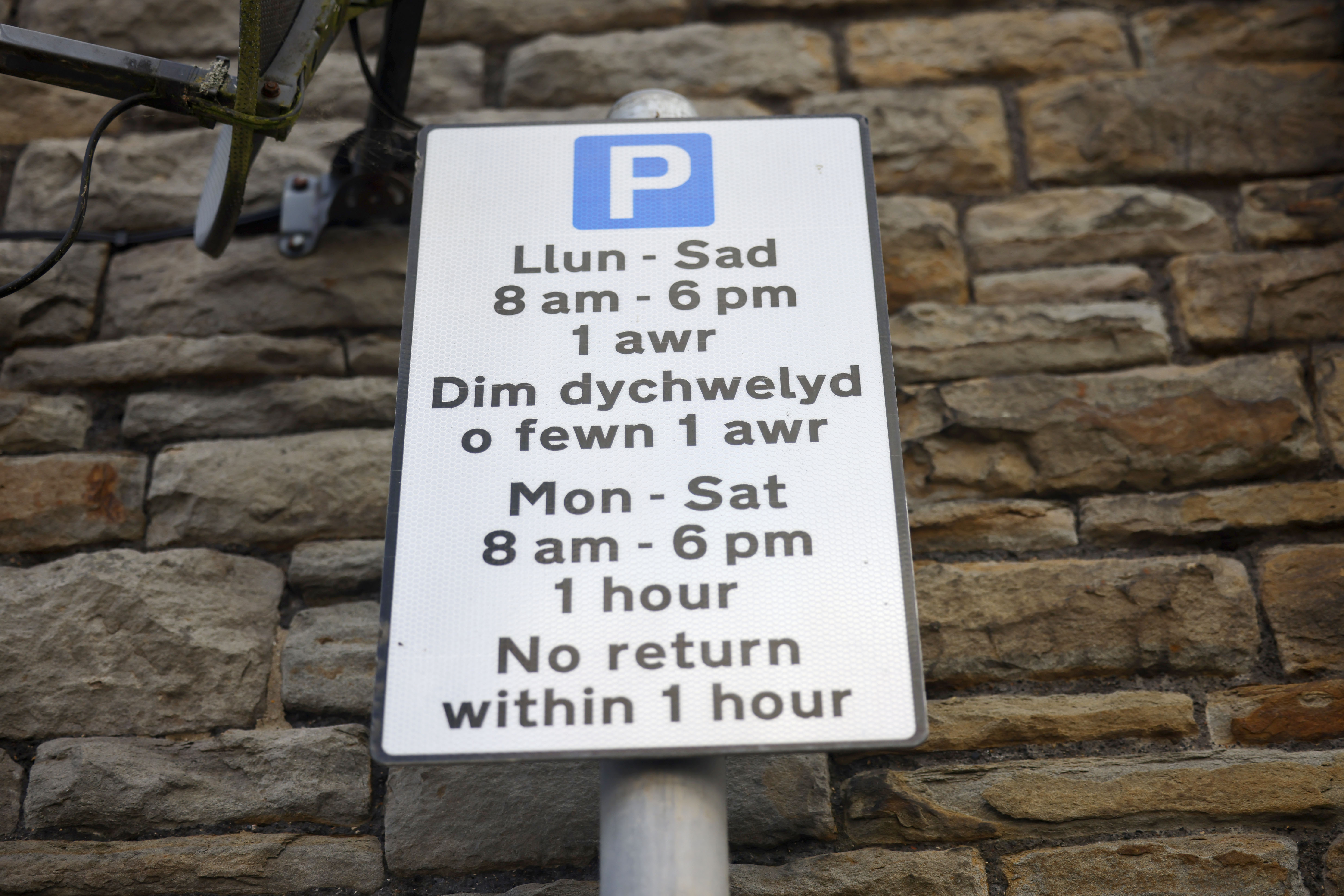 Signage indicating the parking rules for one side of the street