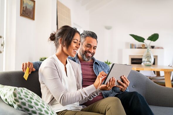 Couple smiling online banking