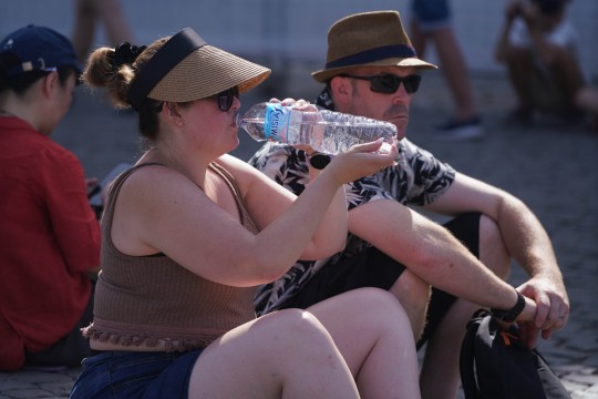 Tourists at the colosseum swelter in the soaring heatwave in Rome, Italy