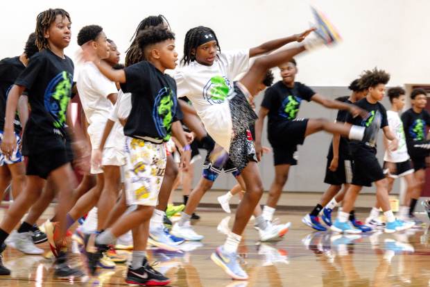 Youth athletes warm up at Camp Jrock, a free basketball...