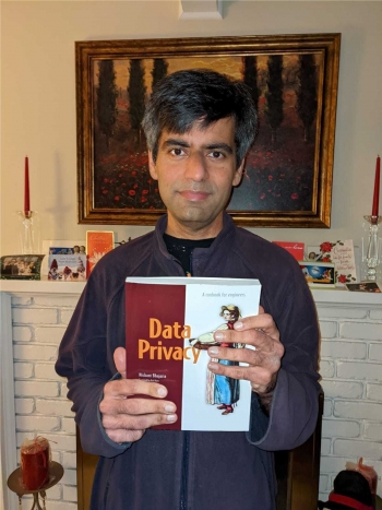 Nishant Bhajaria holding his book "Data Privacy"