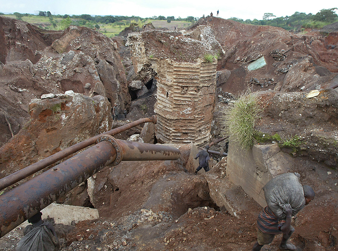 A person carries wet cobalt on his back at the Shinkolobwe cobalt mine in the Democratic Republic of Congo in 2004.


