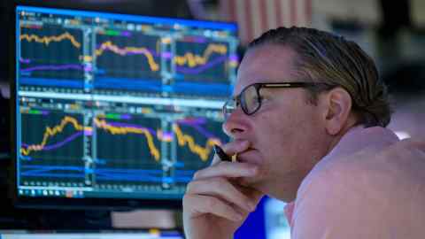 A trader in front of a computer monitor