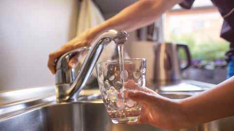 A glass of fresh water being filled from the kitchen tap