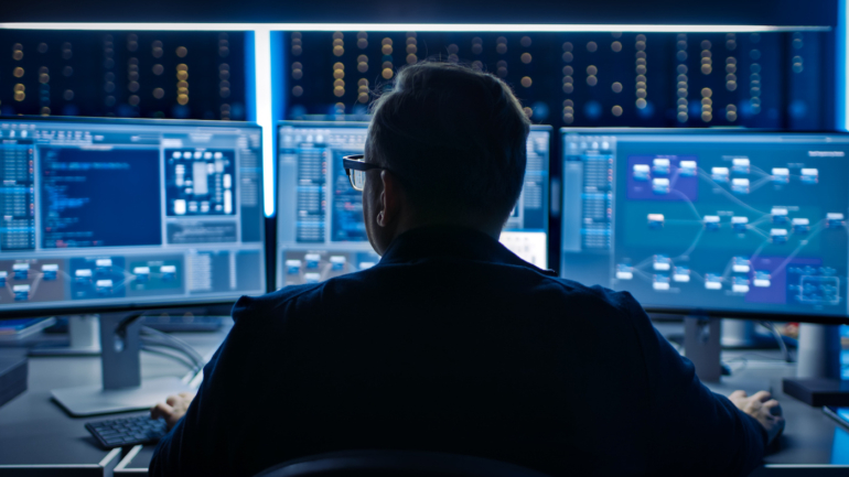 A chief information security officer looking at many screens.