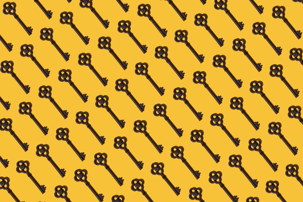 a pattern of antique keys on a yellow mustard background