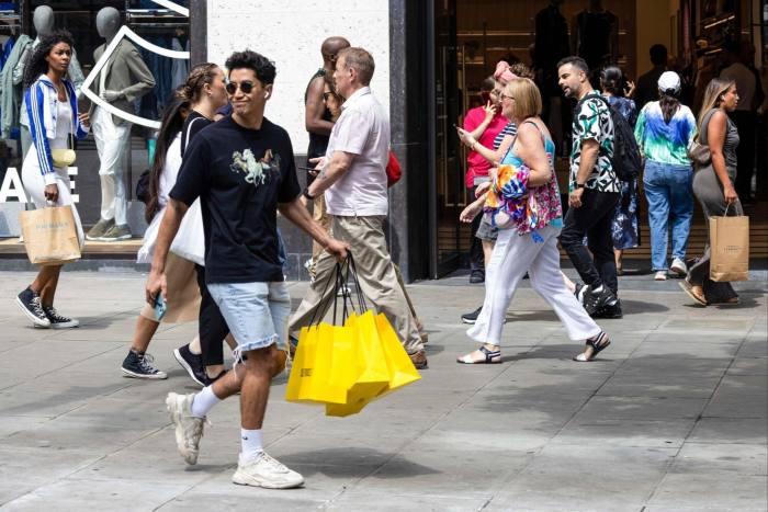 Shoppers walk along Oxford Street in London