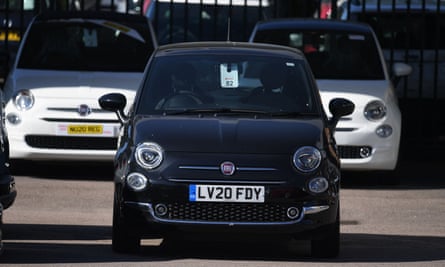 New Fiat cars are seen on the forecourt of a car dealership in Dartford