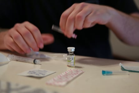 person preparing hormone injection