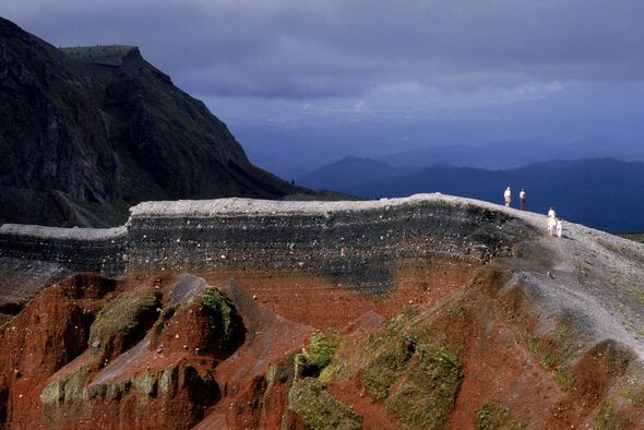 Hikers walk along Tarawera's volcanic rim