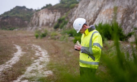 A geologist inspects a rock sample at Trevalour Downs, near St Austell, where Cornish Lithium aims to build ‘a demonstration-scale extraction facility’.