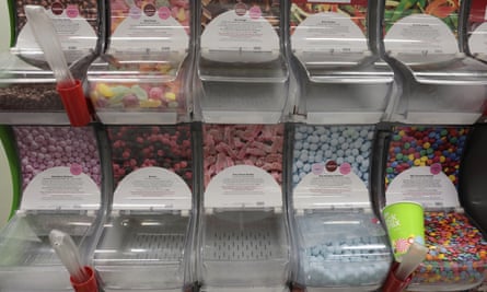 A row of containers of different types of sweets.