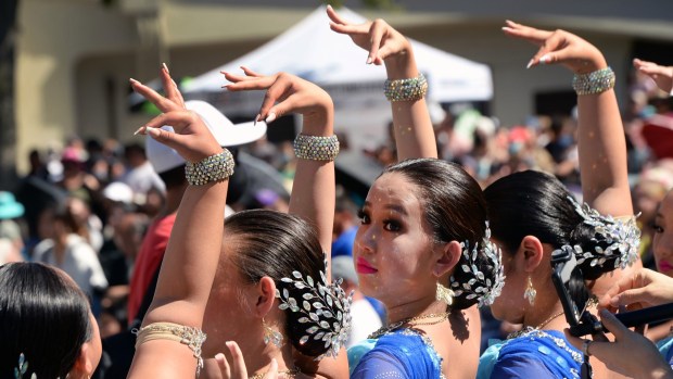 Dancers make OK signs with their hands