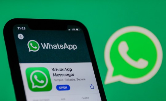 WhatsApp logo on the App Store displayed on a phone screen and WhatsApp logo in the background are seen in this illustration photo taken in Poland on January 14, 2021. Signal and Telegram messenger apps gained popularity due to the new WhatsApp's privacy policy. (Photo illustration by Jakub Porzycki/NurPhoto via Getty Images)