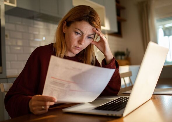 A woman checks her bills