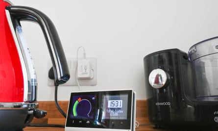 Smart meter in UK kitchen alongside an electric kettle