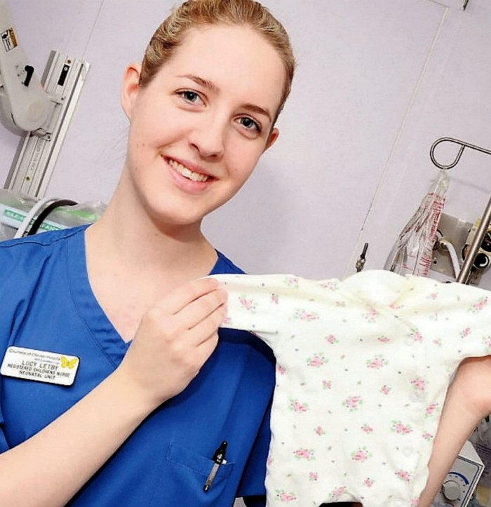 Lucy Letby holding baby clothes