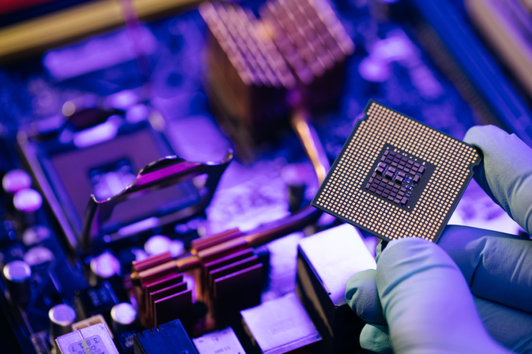 An engineer holding a semiconductor about to be integrated in a circuit.