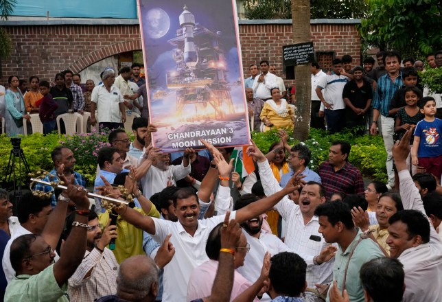 People celebrate as they watch a live telecast of the landing og Chandrayaan-3, or ???moon craft??? in Sanskrit, in Mumbai, India, Wednesday, Aug. 23, 2023. India has landed a spacecraft near the moon???s south pole, an unchartered territory that scientists believe could hold vital reserves of frozen water and precious elements, as the country cements its growing prowess in space and technology. (AP Photo/Rajanish Kakade)